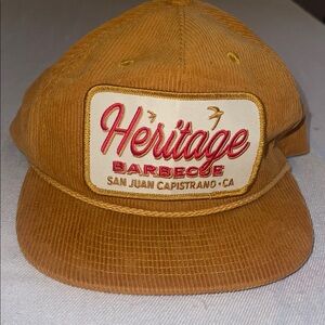 Stylish corduroy tan cap featuring the famous Heritage Barbeque logo outings.